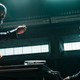 A standing, gesturing Chiwetel Ejiofor confronts a seated Mark Wahlberg in a scene from Infinite.